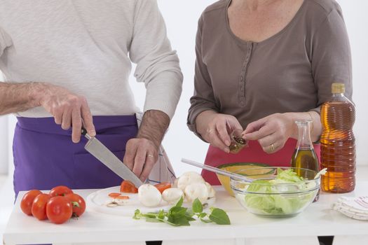 Husband And Wife Preparing Vegetables and salad