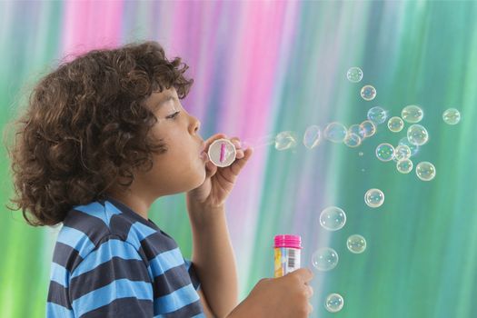 Boy blows up soap bubbles