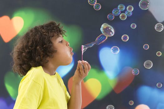 Boy blows up soap bubbles