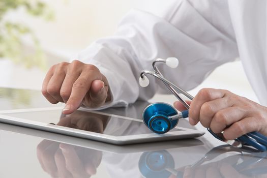 Female doctor using tablet pc