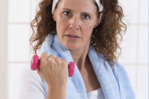 woman with weight training equipment on the gym