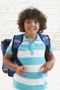 Adorable young kid ready for school with his bag