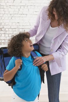Mother prepare boy for school