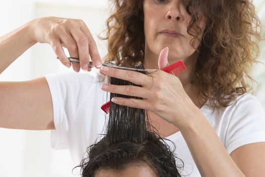 A lovely child in the hairdresser salon cutting his hair