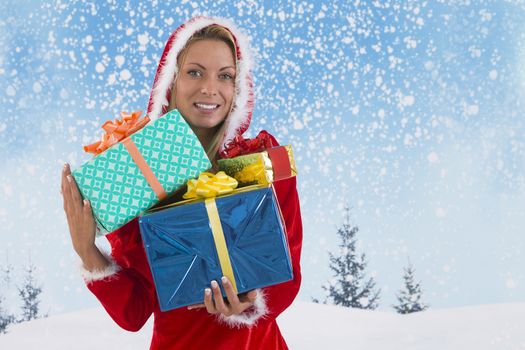 Beautiful young woman in Santa Claus clothes  with gifts on blue sky background