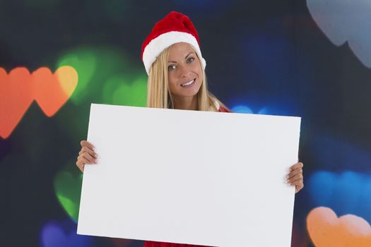 beautiful girl in red Santa Claus costume holding a blank board
