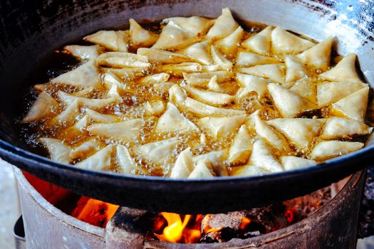 Detail of rustic pan and frying pasta in oil