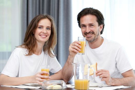 couple eating breakfast at kitchen