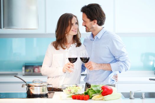 couple cooking dinner at kitchen