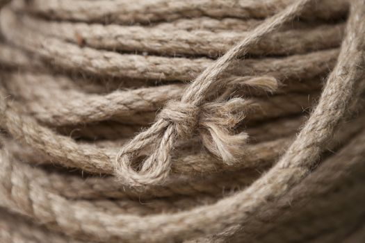 Coil of rope with marine knot loop. Roll of ship ropes as background texture