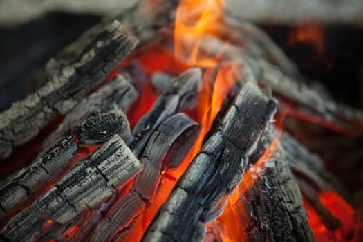 Beautiful fire with flames charred wood.