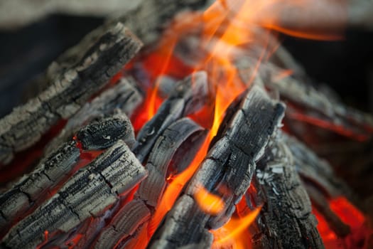 Beautiful fire with flames charred wood.