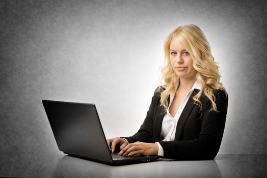Blond business woman working frustrated on laptop