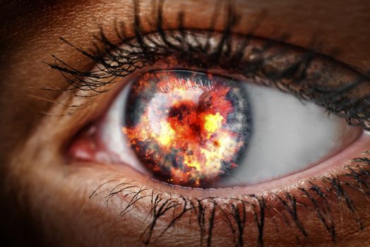 Closeup of the eye of a woman with fire