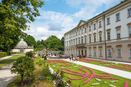 Salzburg, Austria - June 25, 2014: Mirabell Garden with Orangerie building on the left, a famous tourist destination of the Mozart city.