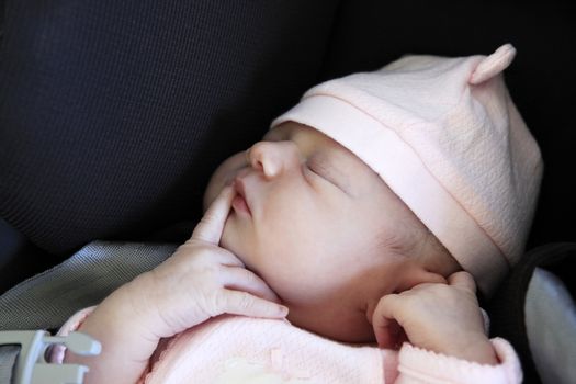 Sleeping newborn baby. The first days of life of the newborn girl