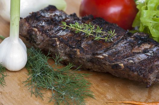 Grilled spiced pork ribs with thyme, close up