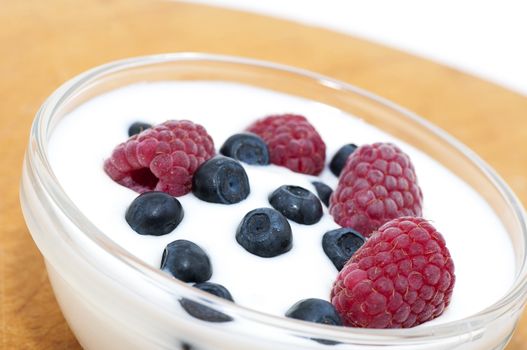 Delicious dessert made of yoghurt and ripe berries (raspberry and blueberry)