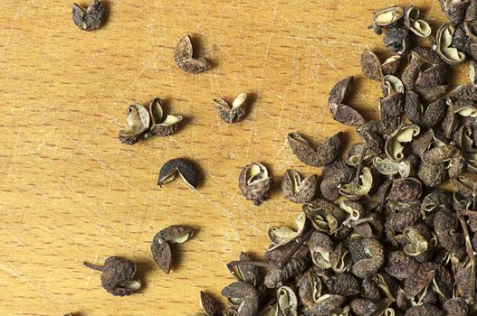 Sichuan pepper on cutting board close up