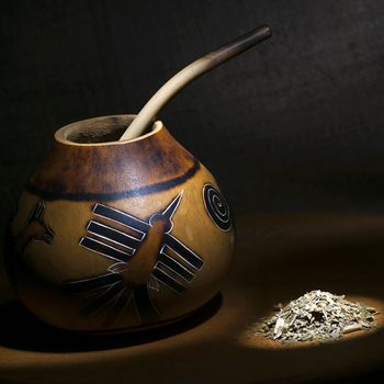 Traditional calabash gourd and yerba mate still life light brush technique