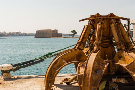 Robot arm of crane, heavy machine for industry at port.