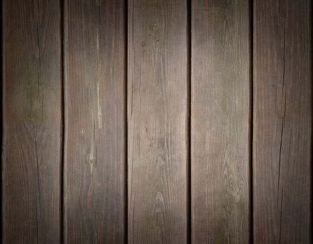 Weathered wooden plank background texture with dark vignette around edges