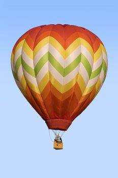 Hot-air balloon floating against blue sky background