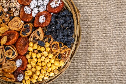 Wicker basket with dried fruits, raisins and nuts. Healthy oriental snacks