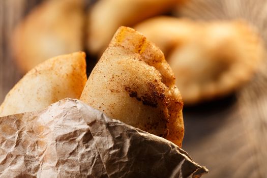 Fried colombian empanadas on wooden table. Savory stuffed patties also known as pastel,pate or pirozhki