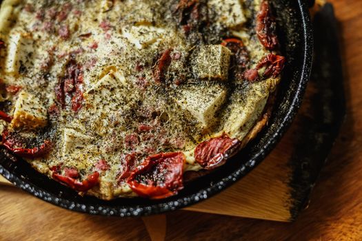 Omelette with smoked cheese, sausages and sundried tomatoes. Healthy dinner. Slow food