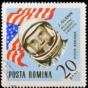 ROMANIA - CIRCA 1963: A stamp printed in Romania shows USA flag and portrait of astronaut John Glenn, with the same inscription, from the series "Space Navigation", circa 1963