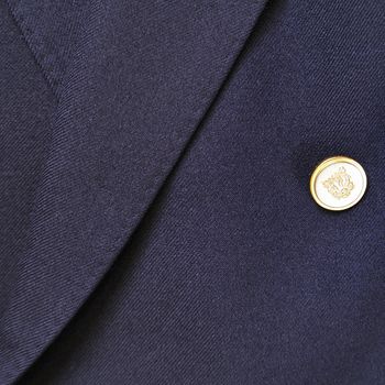 Close-up of a classic blue wool suit with button