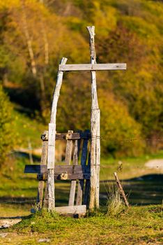 Wooden rustic pedestrian gate and a fence with barbed wire for grazing in mountain. Monte Baldo, Verona, Veneto, Italy
