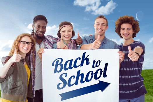 Fashion students smiling at camera together against green field under blue sky