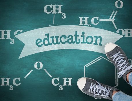 The word education and casual shoes against green chalkboard