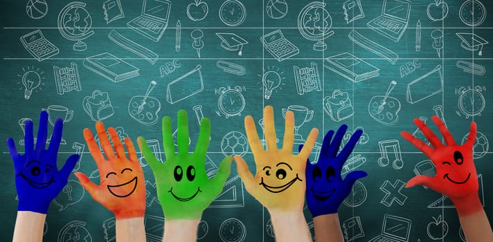 Hands with colourful smiley faces against green chalkboard