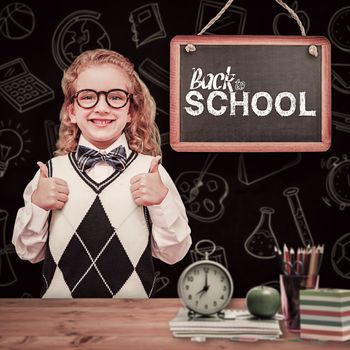 Cute pupil with thumbs up against bleached wooden planks background