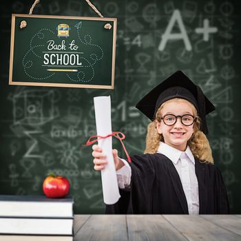 Schoolgirl with graduation robe and holding her diploma against pale grey wooden planks