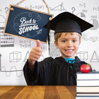 Cute pupil in graduation robe against wooden surface with planks