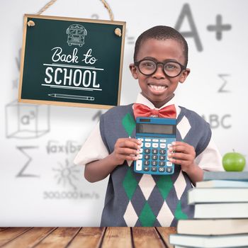 Happy pupil with calculator  against wooden planks background