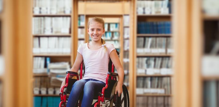 Girl sitting in wheelchair in school corridor against library