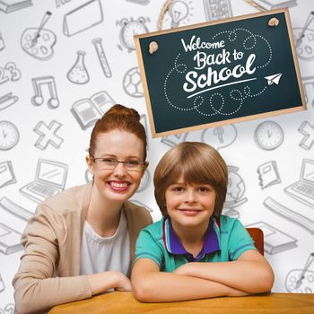 Happy pupil and teacher against grey background