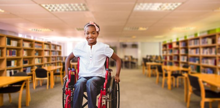 Girl sitting in wheelchair in school corridor against view of library