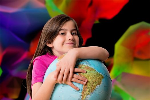 Cute pupil smiling holding globe against colourful abstract design