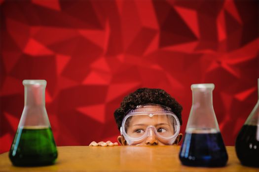 Cute pupil dressed up as scientist against red abstract design