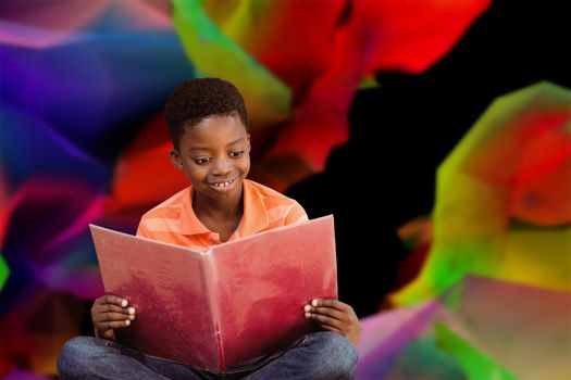 Cute boy reading book in library against colourful abstract design