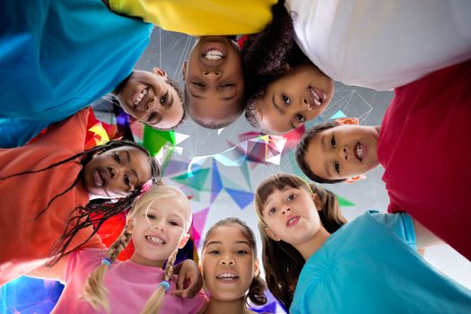 Elementary pupils smiling against geometric design