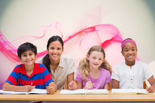Pretty teacher helping pupils in library against pink abstract design