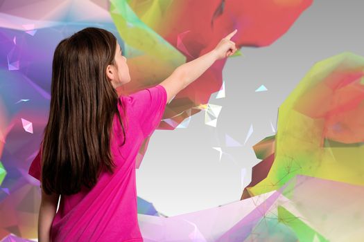 Cute little girl pointing with finger against colourful abstract design