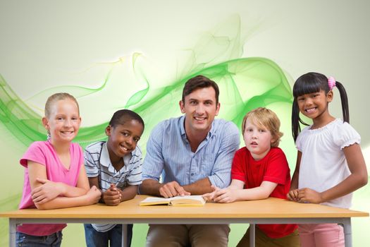 Teacher and pupils smiling at camera at library  against green abstract design